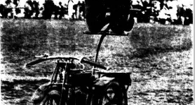 A nespaper photograp[h of Dennis Brandish perfroming a stunt on an AJS350 motor cycle