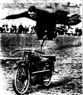 A nespaper photograp[h of Dennis Brandish perfroming a stunt on an AJS350 motor cycle